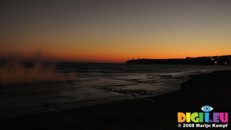 SX00738 Spray of waves at Tramore promenade during sunset (metal man towers)